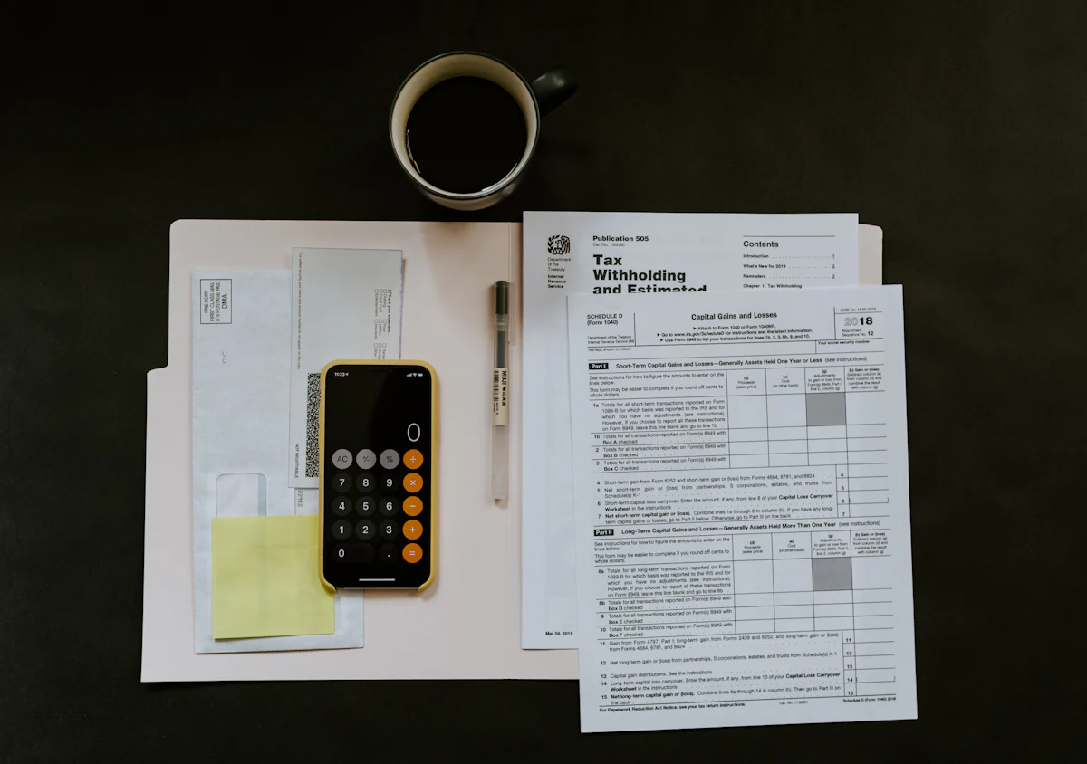 Tax forms and a calculator used to trace hidden assets in a Nevada divorce